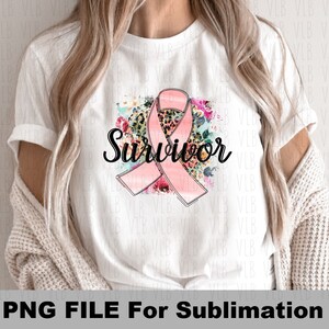 May include: A white t-shirt with a pink ribbon, floral and leopard print design, and the word "Survivor" in black lettering.