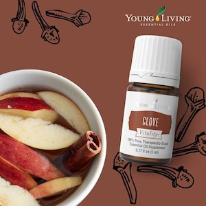 May include: A brown bottle of Young Living Clove Vitality essential oil, 0.17 fl oz (5 ml), with a white cap. The image includes a bowl of apple slices and a cinnamon stick, and clove illustrations.