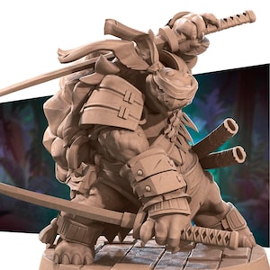 May include: A detailed, tan-coloured figurine of a turtle-like character in samurai armour, holding two katanas. The figure is posed in a dynamic stance, with intricate details on the armour and weapons. The figure is on a stone-like base.