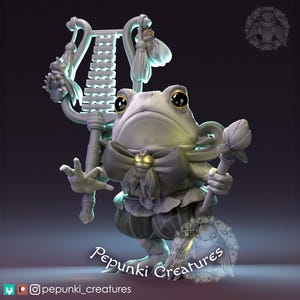 May include: A whimsical, gray frog figurine with large eyes, a bow tie, and a lyre. The frog is holding a staff with a flower and is wearing a ruffled outfit. The figurine is labeled "Pepunki Creatures".