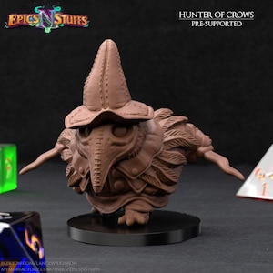 May include: A brown, pre-supported miniature figure of a creature with a long beak and a hat, labeled "Hunter of Crows." The figure is on a black base, with the "Epics N Stuffs" logo in the upper left corner. Dice are visible in the background.