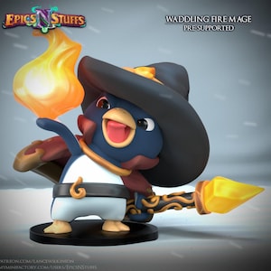 May include: A figurine of a waddling fire mage, a penguin-like character with a blue and white body, wearing a black hat and holding a flaming torch. The figurine has a joyful expression and is standing on a black base. The text "EPICS N STUFFS" and "WADDLING FIRE MAGE PRE SUPPORTED" are visible.