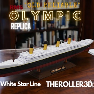 May include: A white and black model ship replica of the RMS Olympic, a White Star Line ocean liner. The model is on a base with the text "RMS Olympic 1911". The text "RMS "OLD RELIABLE" OLYMPIC REPLICA" is in the upper left corner of the image. The text "White Star Line THEROLLER3D 46" is in the lower right corner of the image.