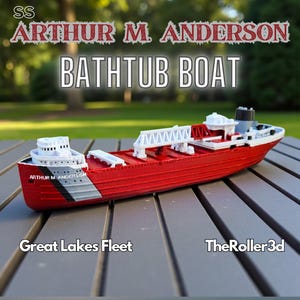 May include: A red and white model of the SS Arthur M. Anderson bathtub boat. The model has a detailed design with white structures, a red hull, and the text "Great Lakes Fleet" and "TheRoller3d". The model is on a wooden surface.