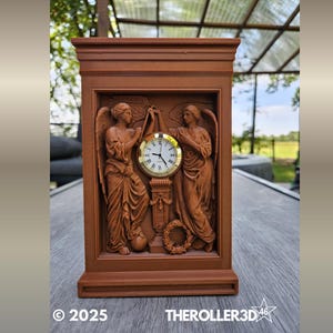 May include: A brown wooden clock with a rectangular base and a detailed relief carving of two angels flanking a clock face. The clock face is gold-colored with black Roman numerals and hands. The text "© 2025 THEROLER3D46" is at the bottom.