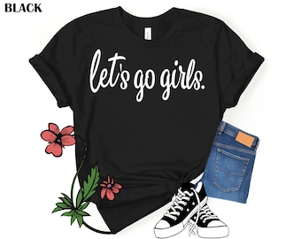 May include: Black t-shirt with white text that reads "Let's go girls."