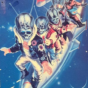May include: A vintage VHS tape for the movie "Spaced Invaders." The cover features a blue background with illustrations of alien characters riding a rocket ship. Text on the cover reads "They're Hip! They're Hilarious!" and "Earth Will Never Be The Same!"