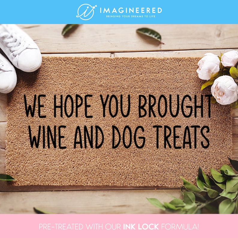 a door mat that says, we hope you brought wine and dog treats