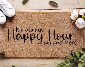 May include: A brown coir doormat with the text "It's always Happy Hour around here" in black lettering. The doormat is pre-treated with an ink lock formula.
