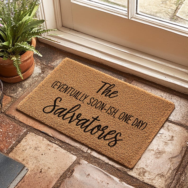 May include: A brown coir doormat with the text "The Salvatores (eventually soon-ish one day)" in black cursive lettering.