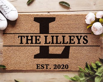 May include: A brown coir doormat with the text "THE LILLEYS EST. 2020" and a large black letter "L" in the center.