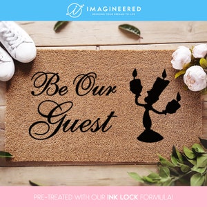 a door mat that says, be our guest