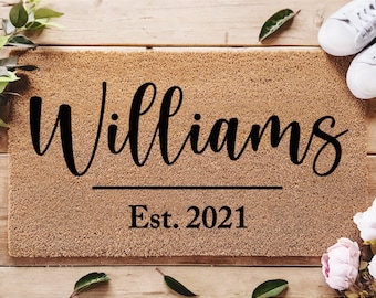 May include: A brown coir doormat with the text "Williams Est. 2021" in black lettering.