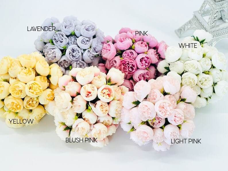 May include: Assortment of artificial flower bouquets in various colors, including lavender, pink, white, yellow, blush pink, and light pink. Each bouquet is made up of small, delicate flowers.