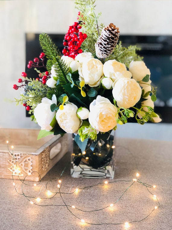 winter white artificial flowers arrangement in glass vase. Faux