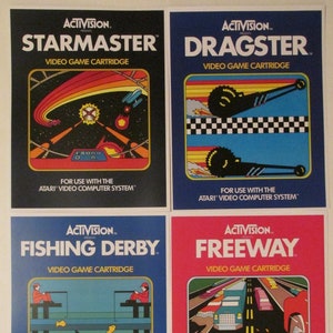 May include: Four vintage Atari video game cartridge boxes. Titles include "Starmaster," "Dragster," "Fishing Derby," and "Freeway." Each box features colorful retro graphics and the Activision logo. The text "Video Game Cartridge" is displayed on each box.
