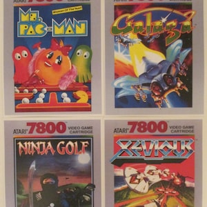 Atari 7800 Video Game Box Art Reproduction Four 8.5x11 Poster Prints - Ms. Pac-Man, Galaga, Ninja Golf, Xevious - Vintage Game Poster Decor. Atari vintage video game cover art from the Atari 2600 retro game console.