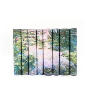 May include: A set of eight vertical book spines arranged side-by-side, featuring a continuous printed reproduction of a water lily pond painting. The artwork displays shades of green, blue, and pink, depicting lily pads and floral blossoms.