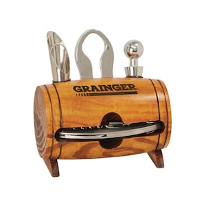May include: A wooden barrel-shaped wine tool set with the word "GRAINGER" printed on the front. The set includes a wine pourer, a bottle opener, a bottle stopper, and a multi-tool. The barrel is made of light brown wood and has small wooden feet.