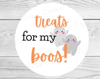 Può includere: Etichetta rotonda bianca con testo arancione che recita "treats for my boos!" con due fantasmi dei cartoni animati con le guance rosa.