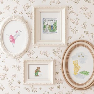 May include: Four framed watercolor prints hang on a floral wallpaper background. The prints include a ballerina pig, a scene with the Eiffel Tower and the name "Madeline", a bear, and Winnie the Pooh with bees.
