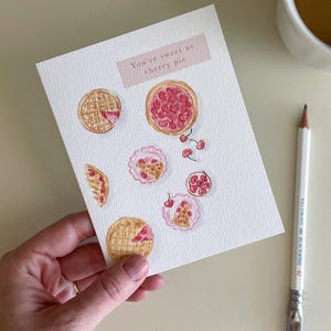 Tarjeta de felicitación con tarta de cerezas: un divertido mensaje de agradecimiento, cumpleaños o para anfitriones, ideal para amantes de la comida.