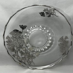 Vintage glass plate with silver overlay.