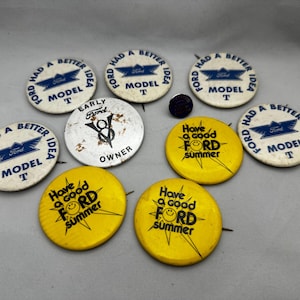 Vintage Ford button pins and a lapel pin.