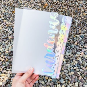 May include: A clear plastic binder with a holographic sticker that says "remarkable" on the front. The sticker has a rainbow iridescent finish and features stars and hearts.