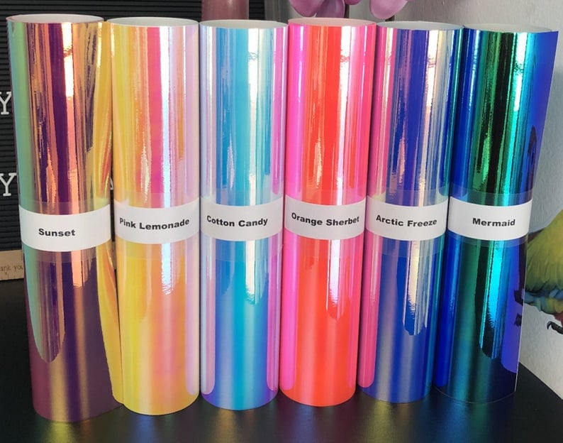 May include: Six rolls of iridescent vinyl in various colors, including sunset, pink lemonade, cotton candy, orange sherbet, arctic freeze, and mermaid.