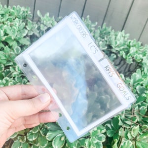 May include: Clear plastic page protectors with tabs labeled "Work Orders", "LC's", and "KPI's Goals".