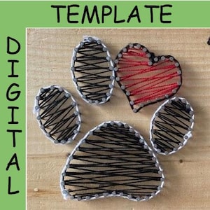 Pode incluir: Um design de arte de fio de uma pegada de pata com um coração vermelho no centro. A pegada de pata é feita com fio preto e branco, e o coração é feito com fio vermelho.