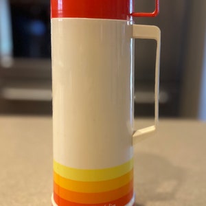 Alladin 1 pint thermos with orange and yellow stripes