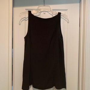 May include: A black sleeveless top with a scoop neck.