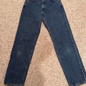 May include: A pair of dark blue denim jeans with a straight leg fit.