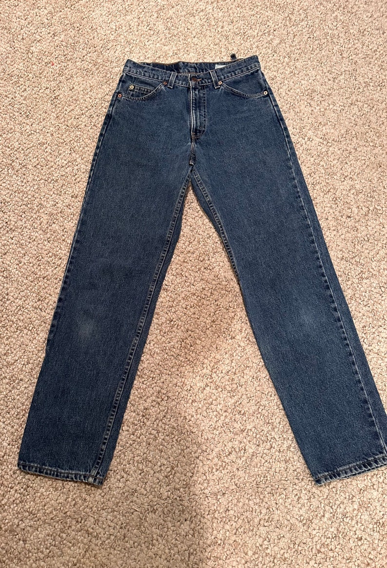 May include: A pair of dark blue denim jeans with a straight leg fit.