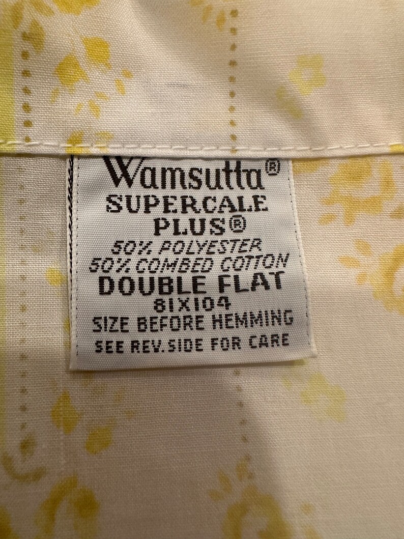 May include: White label with black text that reads "Wamsutta Supercale Plus&reg; 50% Polyester 50% Combed Cotton Double Flat 81x104 Size Before Hemming See Rev. Side For Care"