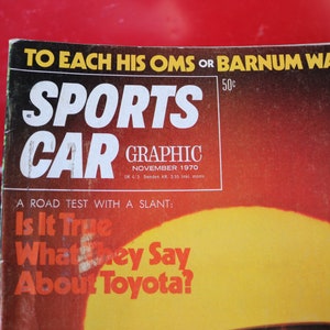 May include: A vintage "Sports Car Graphic" magazine cover from November 1970. The cover features the magazine's title in large white letters, with a red and yellow gradient background. The cover also includes the text "A Road Test With A Slant: Is It True What They Say About Toyota?"