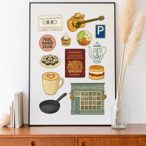 May include: A framed print with illustrated icons including a cassette tape, guitar, parking sign, sushi, passport, teapot, coffee cup, and a frying pan. The print also has the text "Feel Good Club."