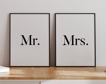 May include: Two black framed prints with white backgrounds. The print on the left says "Mr." and the print on the right says "Mrs."