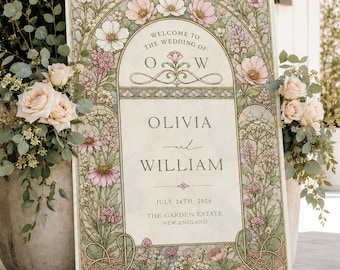 Op de afbeelding: Een rechthoekig welkomstbord voor een bruiloft met een gebogen bloemenrand van roze en witte bloemen en groen blad. De tekst luidt: Welcome to the wedding of O W, Olivia and William, July 14th, 2024, The Garden Estate, New England.