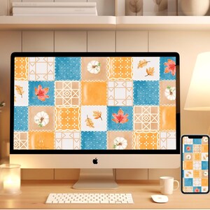 May include: A desktop computer and a mobile phone with matching autumn-themed wallpapers. The wallpapers feature a patchwork design with orange, blue, and white squares, with fall leaves and pumpkins.