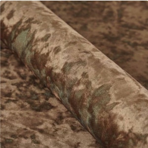 May include: Close-up of a brown and green patterned fabric with a soft, velvety texture.