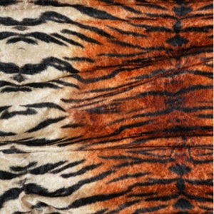 May include: Close-up of a fabric with a tiger print pattern. The fabric is a blend of orange, black, and white colours.