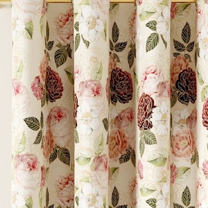 May include: A pair of cream-colored curtains with a floral pattern featuring pink, red, and white roses and green leaves.