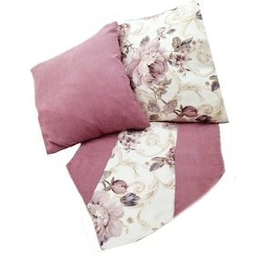 May include: A set of three pink and cream floral patterned throw pillows. The pillows are made of a soft, plush fabric and feature a delicate floral design. The pillows are perfect for adding a touch of elegance to any room.