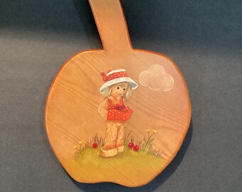 Vintage design of cornhusker girl  painted on apple shaped wood plaque.  Oil paint used.