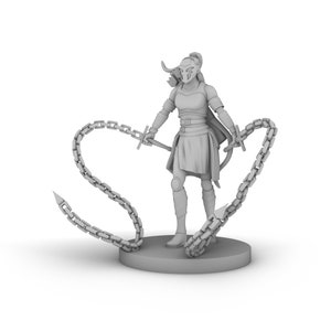 May include: A gray miniature figurine of a female warrior with a horned helmet, holding two chain weapons with spiked ends. The figure is standing on a round base.