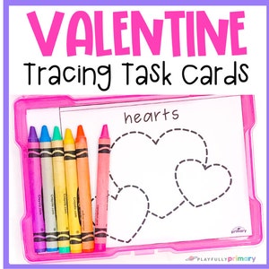May include: A pink plastic tray holds a white tracing task card with dotted hearts and the word "hearts". The tray also contains six colorful crayons: purple, blue, green, yellow, orange, and pink. The text "VALENTINE Tracing Task Cards" is at the top.