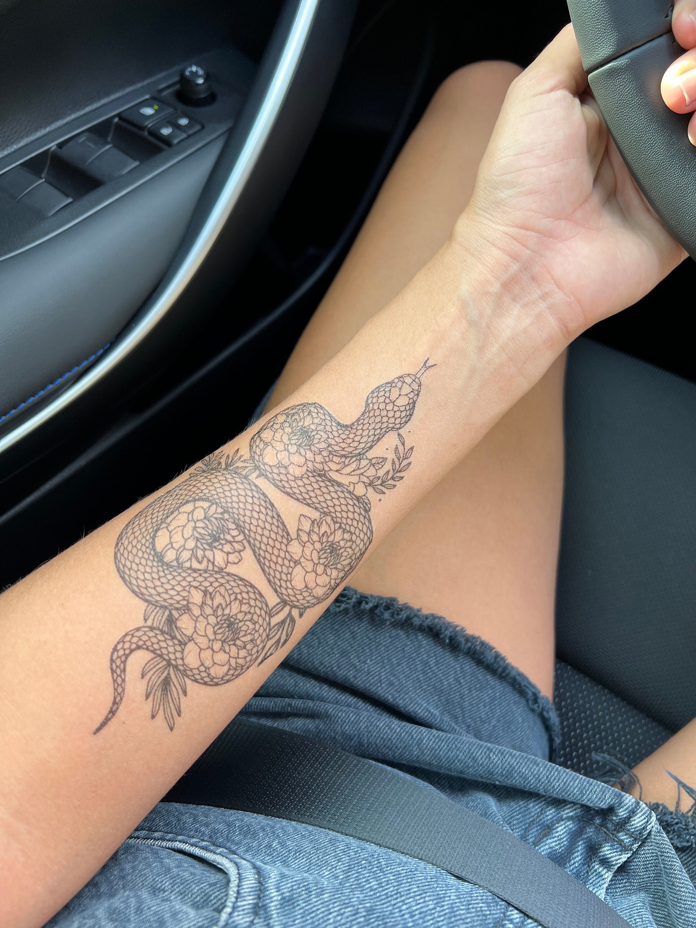 Single needle snake tattoo on the Sydney Parks wrist